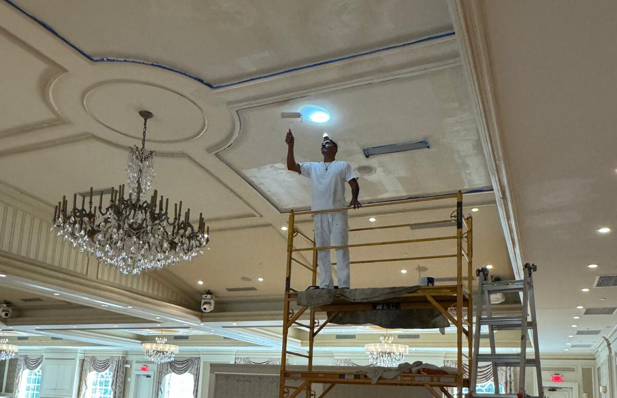 man painting wall